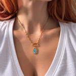 Nadare Co. gold octagon charm necklace with iridescent abalone shell inlay on a delicate chain worn on a model