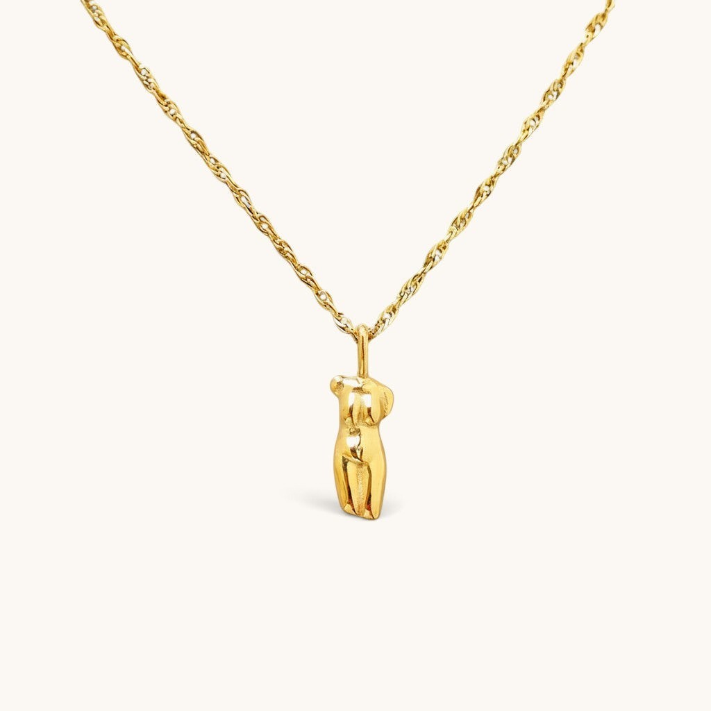 Nadare Co. Aphrodite necklace featuring a gold sculptural female form pendant on a delicate twisted chain.