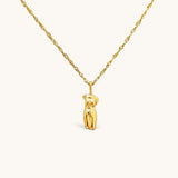 Nadare Co. Aphrodite necklace featuring a gold sculptural female form pendant on a delicate twisted chain.