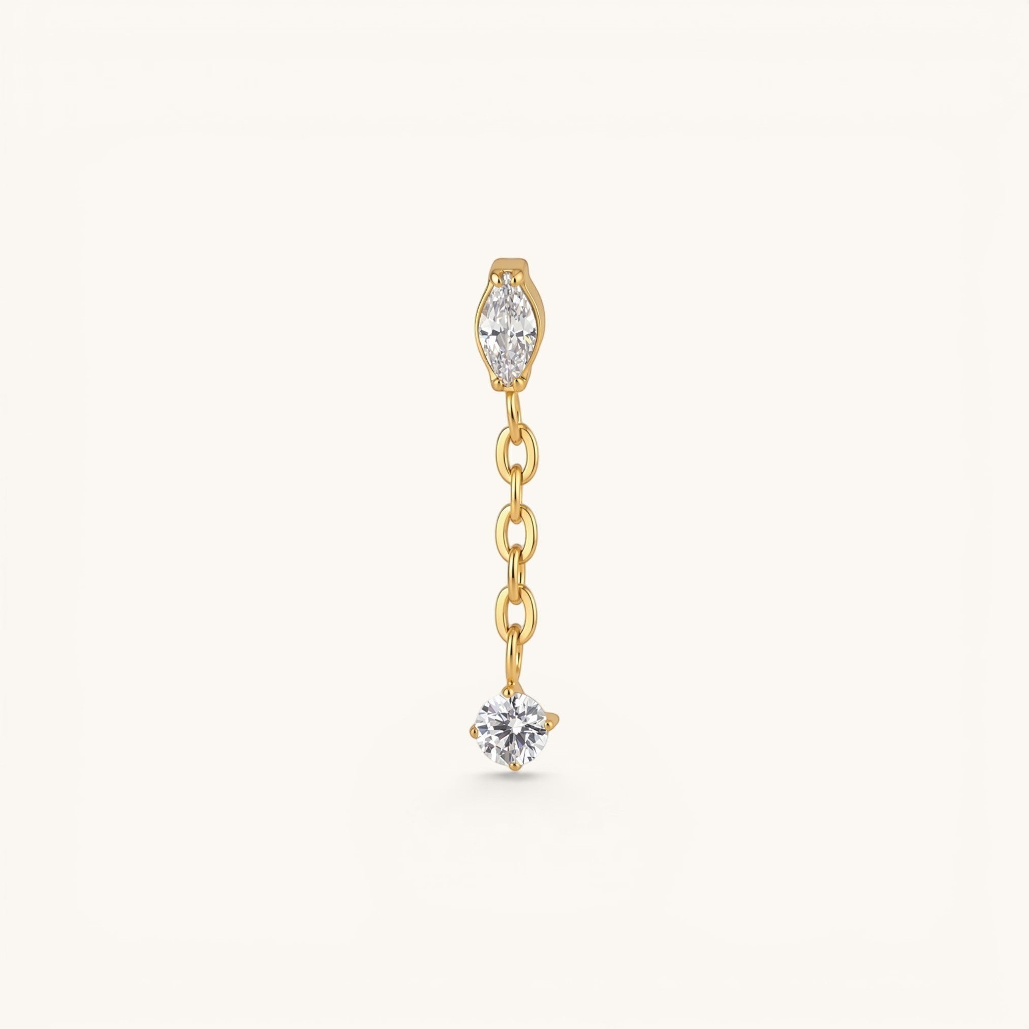 Nadare Co. Aria threadless earring front featuring a marquise-cut and round cubic zirconia connected by a gold chain.
