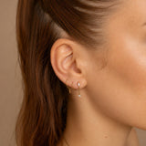Nadare Co. Aria Threadless Front earring featuring a marquise and round cubic zirconia connected by a delicate chain.