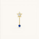 Nadare Co. Astra threadless piercing jewelry featuring a gold star with clear CZ and a sapphire blue CZ drop chain.