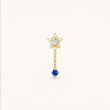 Nadare Co. Astra threadless piercing jewelry featuring a gold star with clear CZ and a sapphire blue CZ drop chain.