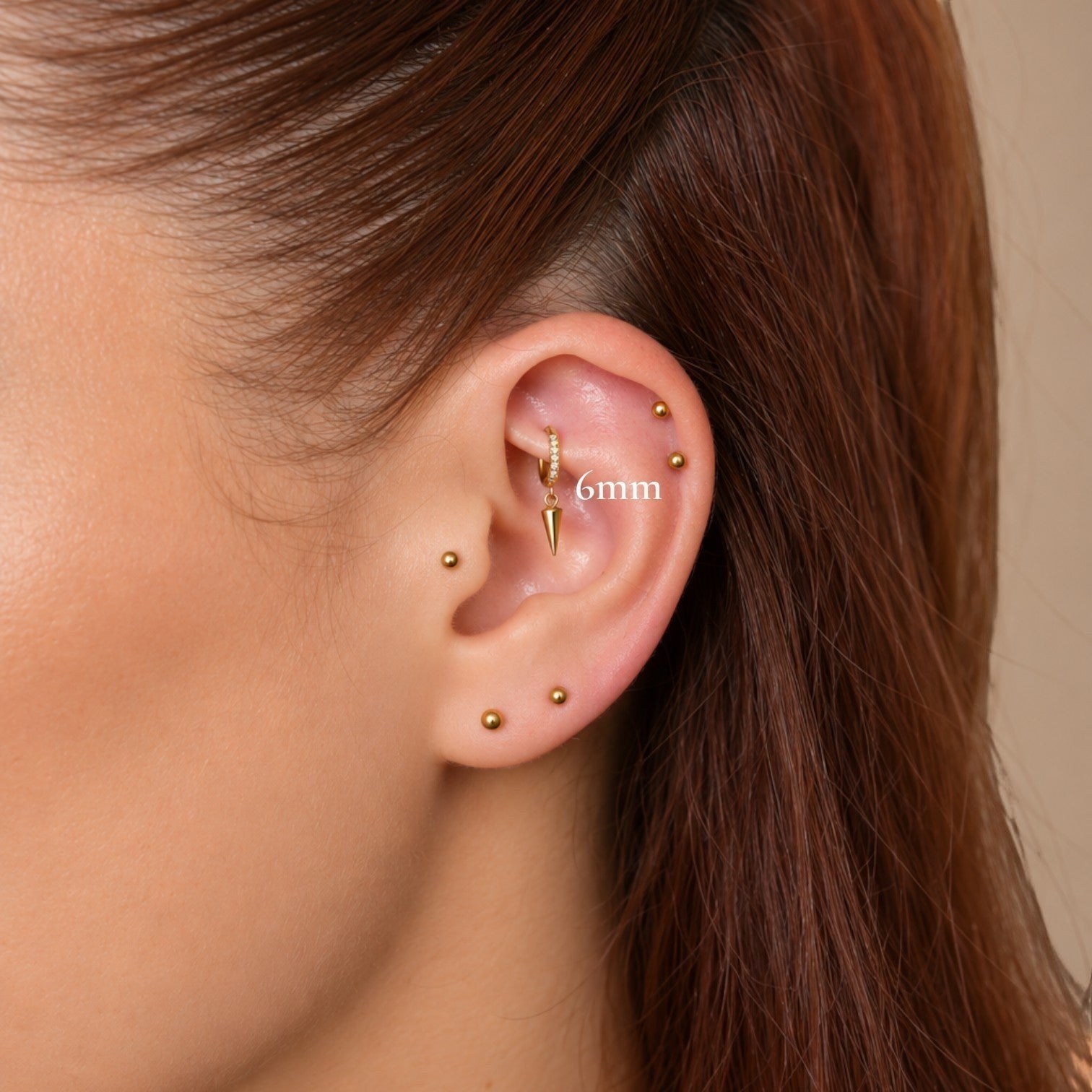 Nadare Co. Atlas Clicker Ring with cubic zirconia and a removable spike charm worn in a rook piercing