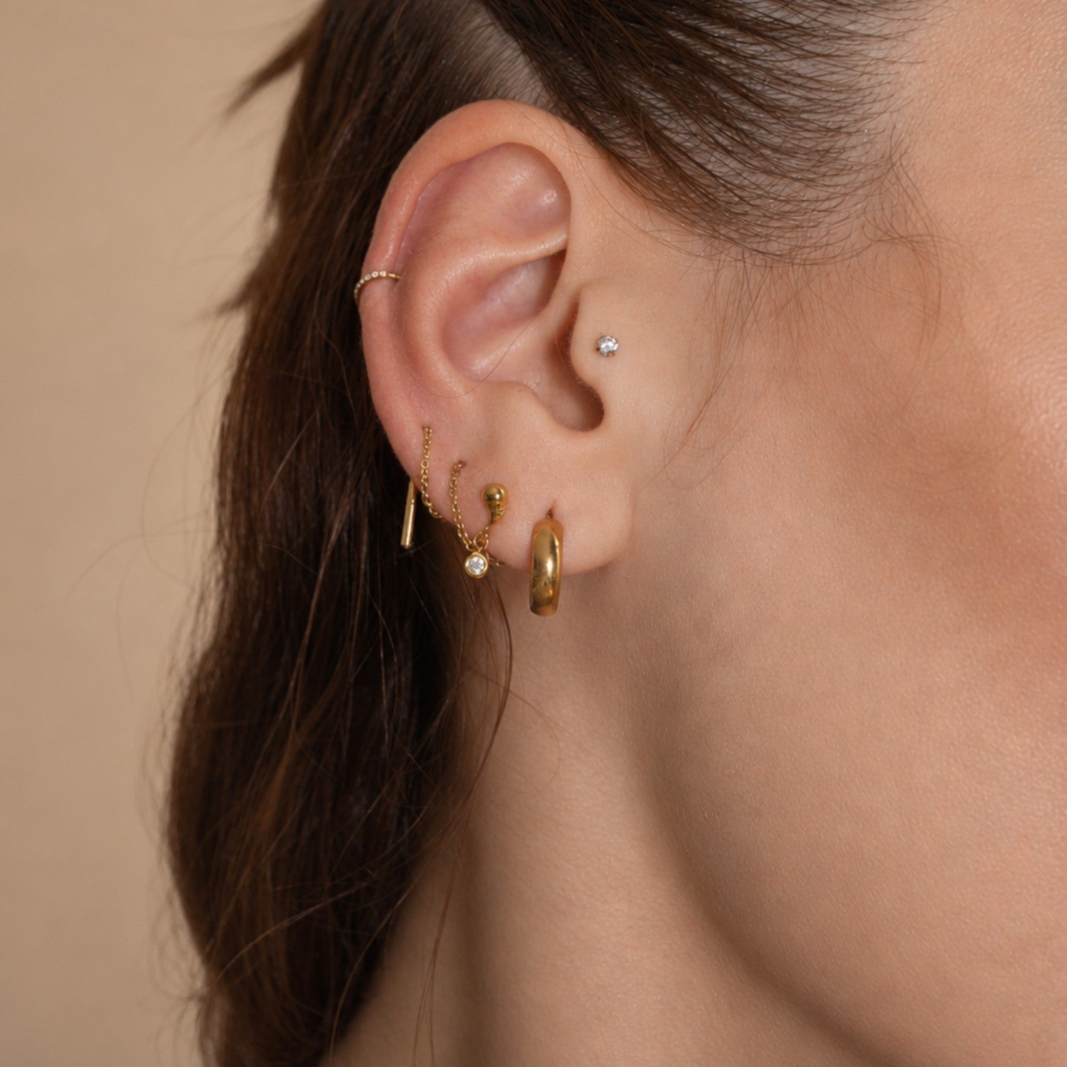 Nadare Co. Aura Threadless Front earring featuring a polished organic shape and bezel-set cubic zirconia drop.