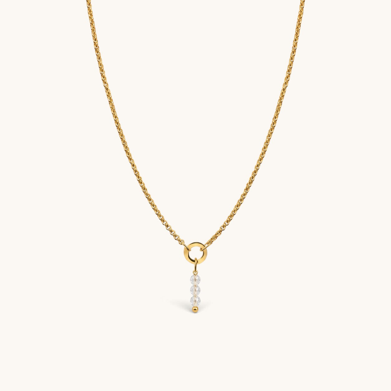 Nadare Co. gold chain necklace featuring a delicate charm with three clear faceted birth month beads