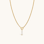 Nadare Co. gold chain necklace featuring a delicate charm with three clear faceted birth month beads