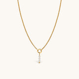 Nadare Co. gold chain necklace featuring a delicate charm with three clear faceted birth month beads