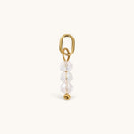 Nadare Co. birth month bead charm featuring three clear faceted beads and a gold jump ring for necklace stacking.
