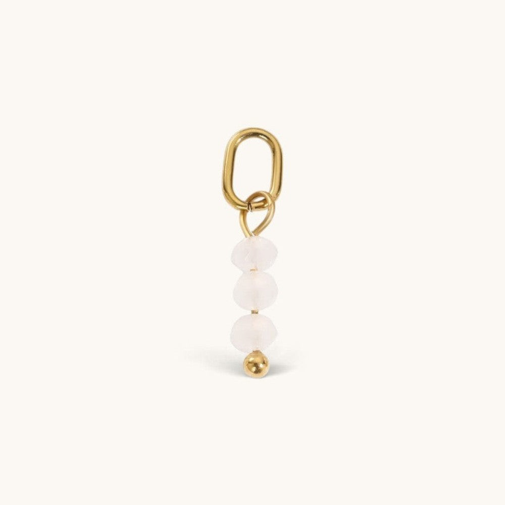Nadare Co. Birth Month Bead Charm featuring three pale pink faceted beads and a gold jump ring for necklace stacking.