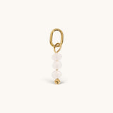 Nadare Co. Birth Month Bead Charm featuring three pale pink faceted beads and a gold jump ring for necklace stacking.