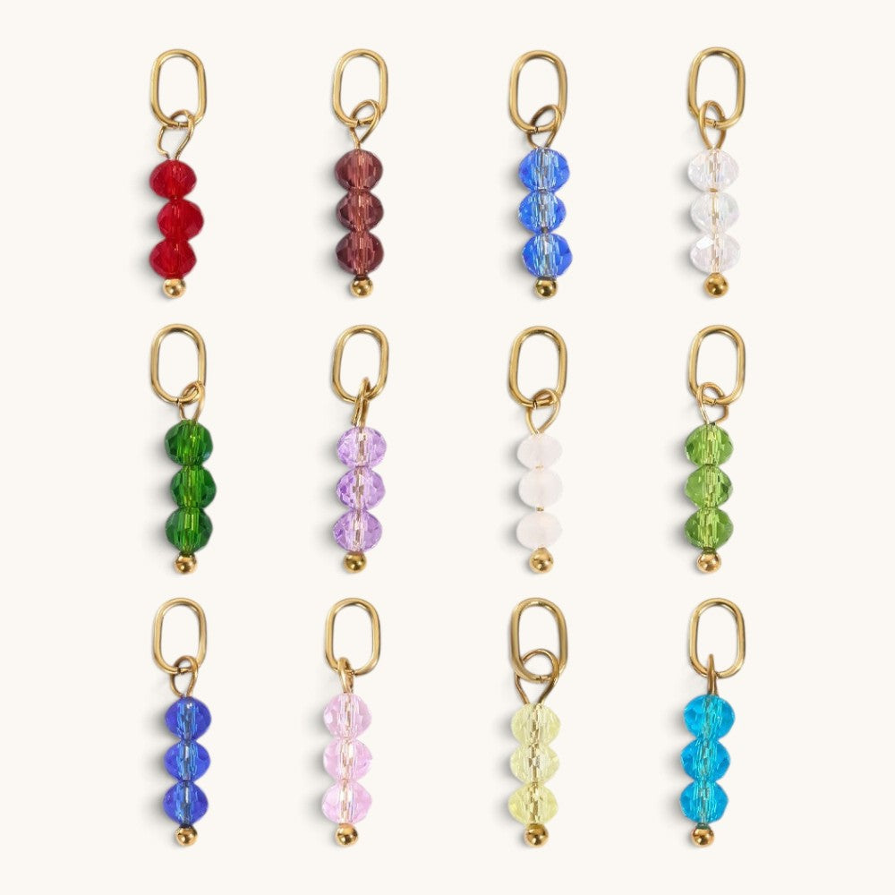 Nadare Co. birth month bead charms featuring three faceted colorful beads on gold rings for personalized necklaces