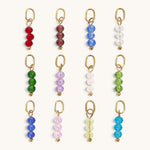 Nadare Co. birth month bead charms featuring three faceted colorful beads on gold rings for personalized necklaces