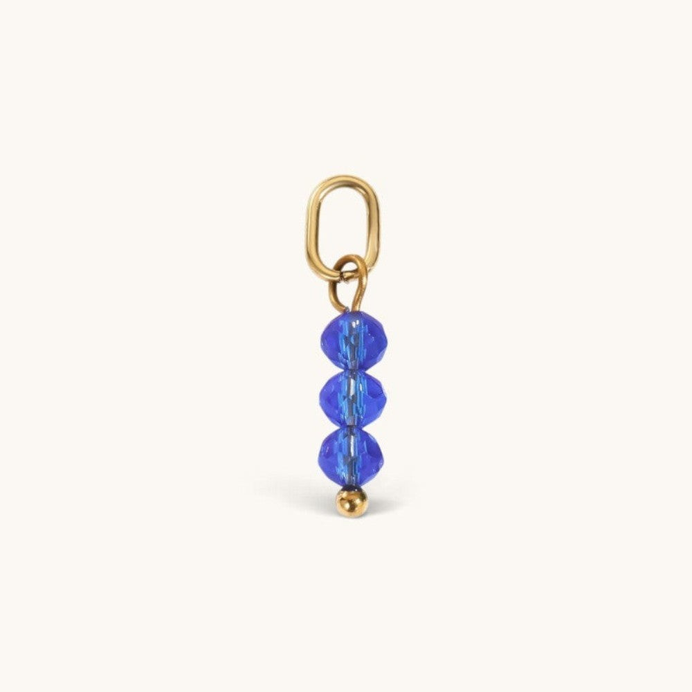 Nadare Co. birth month bead charm featuring three faceted blue crystals on a gold jump ring