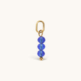 Nadare Co. birth month bead charm featuring three faceted blue crystals on a gold jump ring