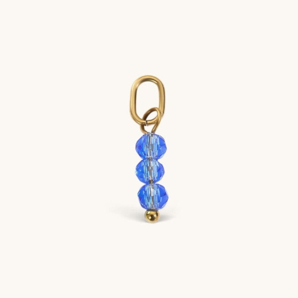 Nadare Co. birth month bead charm featuring three faceted blue crystals on a gold jump ring