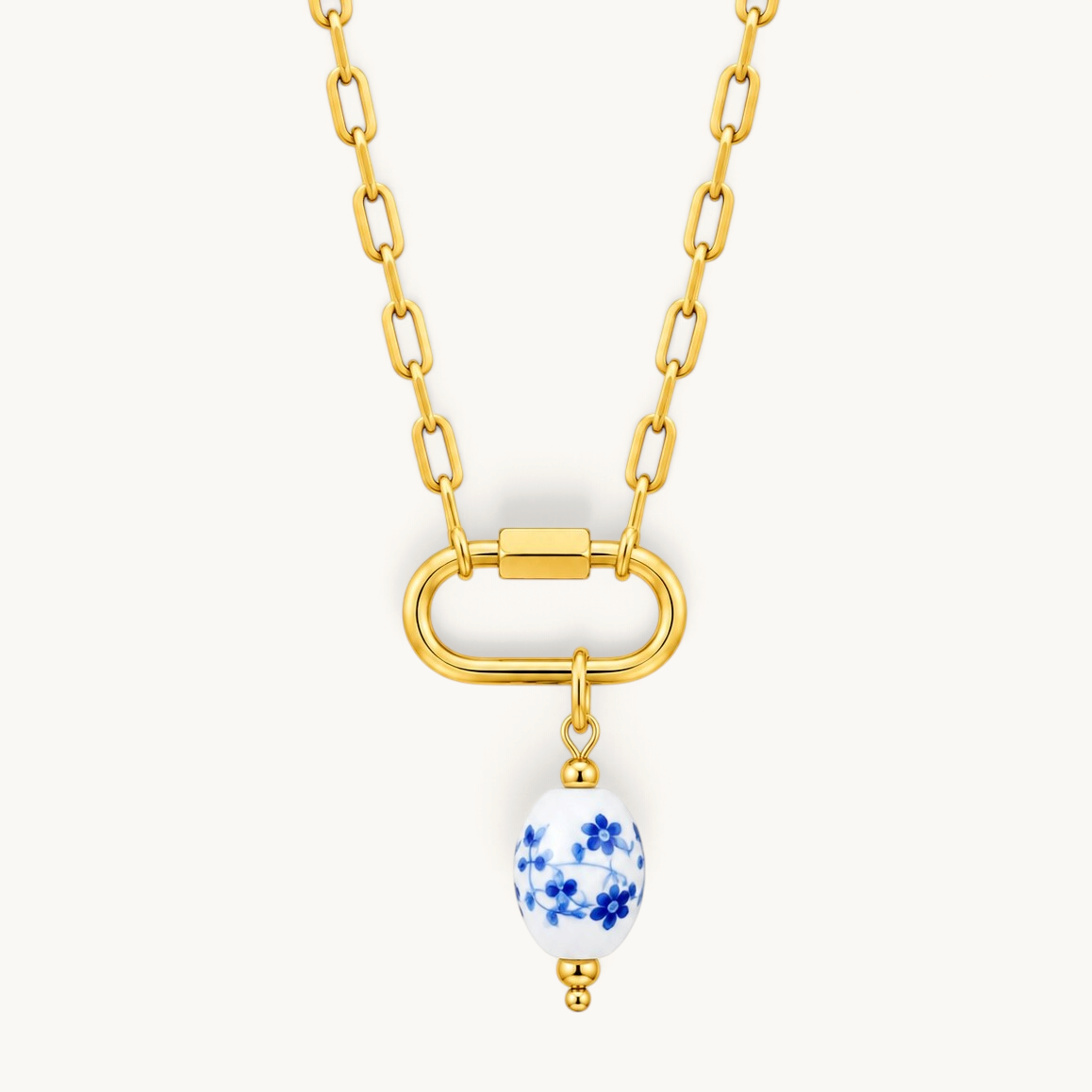 Nadare Co. blue floral porcelain oval bead charm on a gold link chain necklace with 14k gold plating.