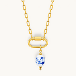 Nadare Co. blue floral porcelain oval bead charm on a gold link chain necklace with 14k gold plating.