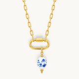 Nadare Co. blue floral porcelain oval bead charm on a gold link chain necklace with 14k gold plating.