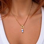 Nadare Co. blue floral porcelain tube bead charm on a 14k gold plated stainless steel chain necklace.
