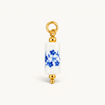 Nadare Co. blue floral porcelain tube bead charm with 14k gold plated stainless steel accents.