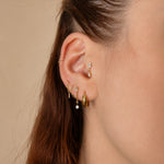 Nadare Co. Camille Threadless Front earring with two marquise-cut cubic zirconia stones worn in a gold ear piercing.