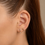Nadare Co. Camille Threadless Front earring with two marquise-cut cubic zirconia stones worn in a gold lobe piercing.