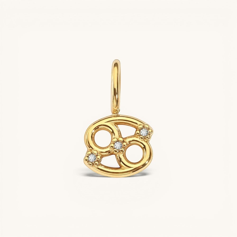 Nadare Co. gold-plated Cancer zodiac charm with cubic zirconia accents on a stainless steel base.