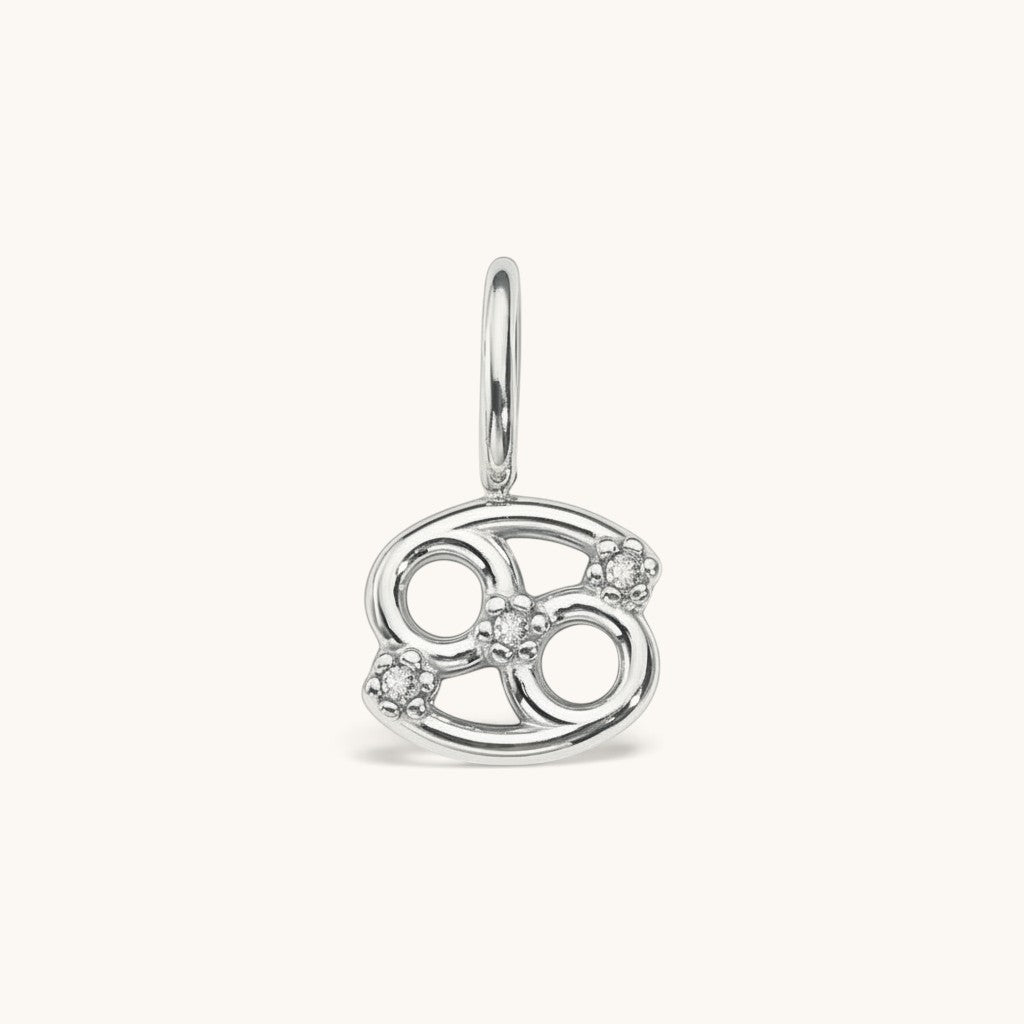Nadare Co. silver-toned Cancer zodiac charm featuring cubic zirconia accents for a delicate, layered necklace look.