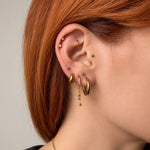 Nadare Co. Cascade Ear Charm featuring three delicate gold chains with polished beads worn on a gold clicker hoop.