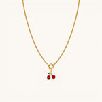 Nadare Co. Cherry Charm gold chain necklace with a small red cherry pendant and green leaf detail.