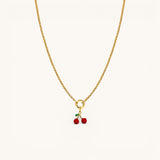 Nadare Co. Cherry Charm gold chain necklace with a small red cherry pendant and green leaf detail.