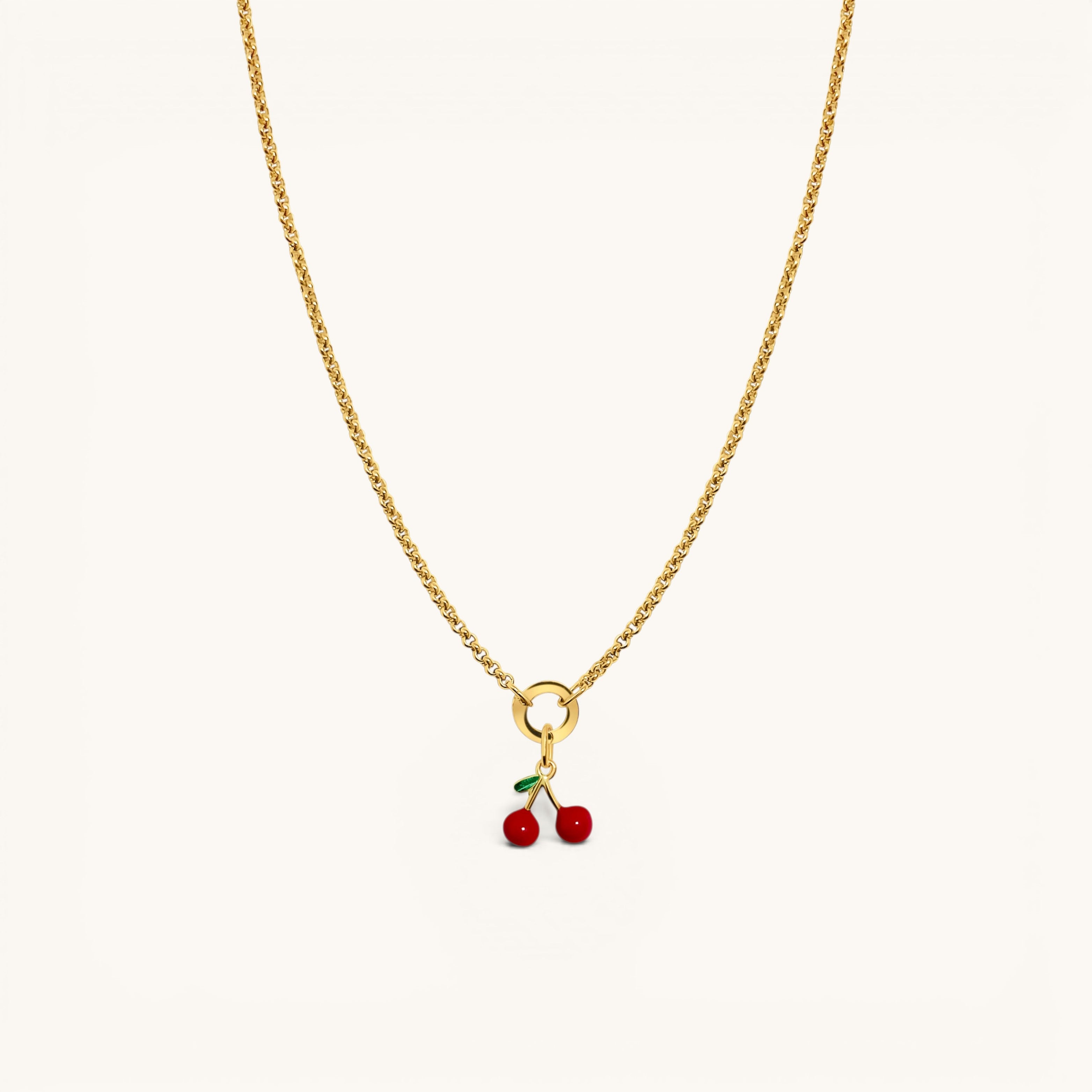 Nadare Co. Cherry Charm gold chain necklace with a small red cherry pendant and green leaf detail.