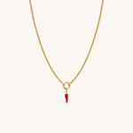 Nadare Co. gold chain necklace featuring a small red enamel chili pepper charm on a circular pendant loop.