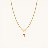 Nadare Co. gold chain necklace featuring a small red enamel chili pepper charm on a circular pendant loop.