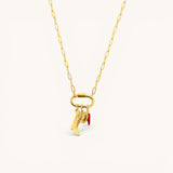 Nadare Co. gold chain necklace featuring a cowboy boot and red chili pepper charm on a carabiner clasp.