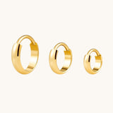 Nadare Co. Cleo Clicker Hoops in polished gold-tone titanium with a secure hinged closure in three different sizes.