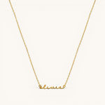 Nadare Co. gold-plated stainless steel cursive name necklace with delicate chain on a light background.