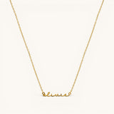Nadare Co. gold-plated stainless steel cursive name necklace with delicate chain on a light background.