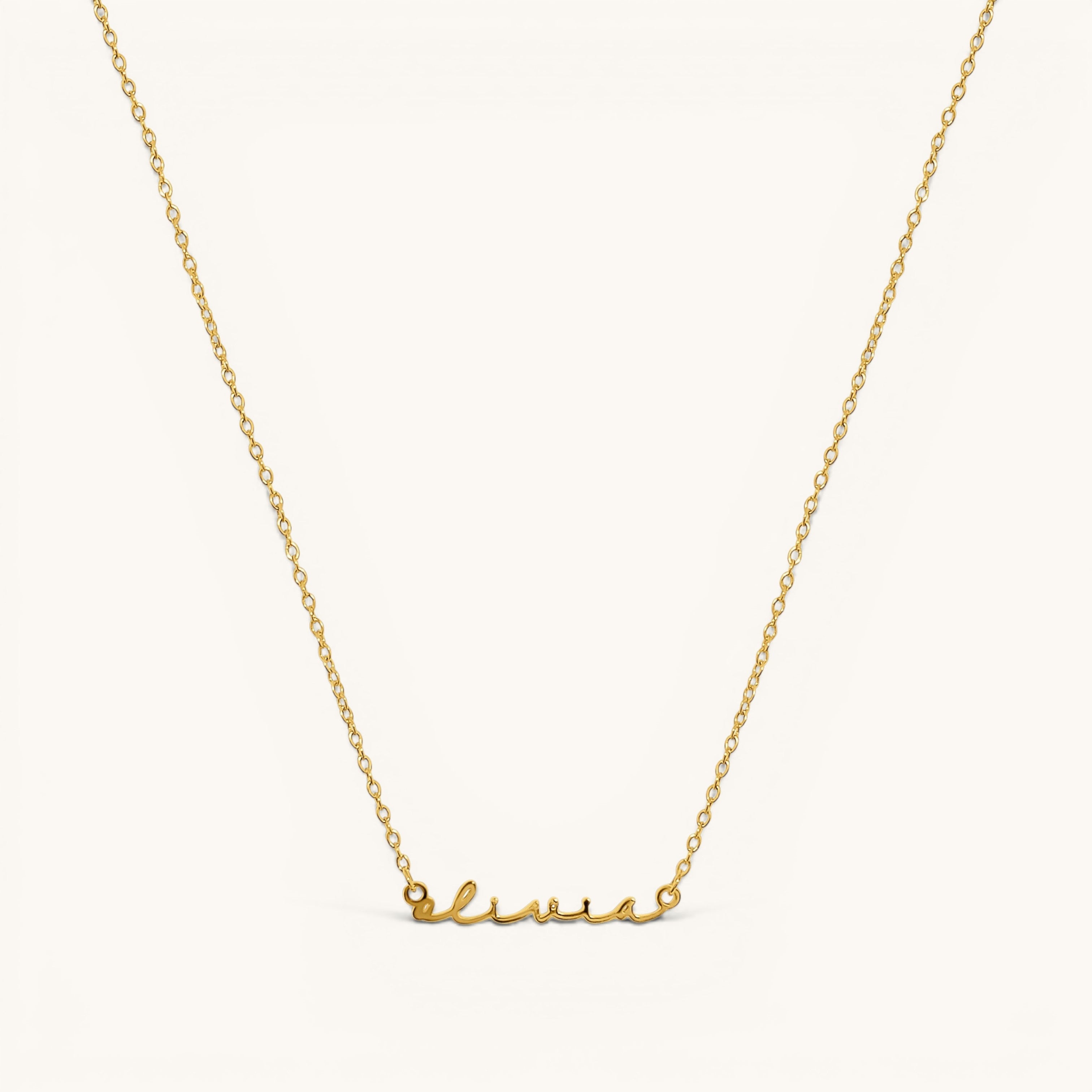 Nadare Co. gold-plated stainless steel cursive name necklace with delicate chain on a light background.