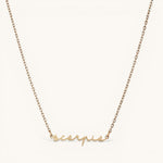 Nadare Co. gold plated stainless steel cursive name necklace featuring a Scorpio zodiac script pendant.