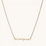 Nadare Co. gold plated stainless steel cursive name necklace featuring a Scorpio zodiac script pendant.