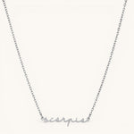 Nadare Co. silver stainless steel cursive name necklace featuring the word Scorpio in elegant script font.