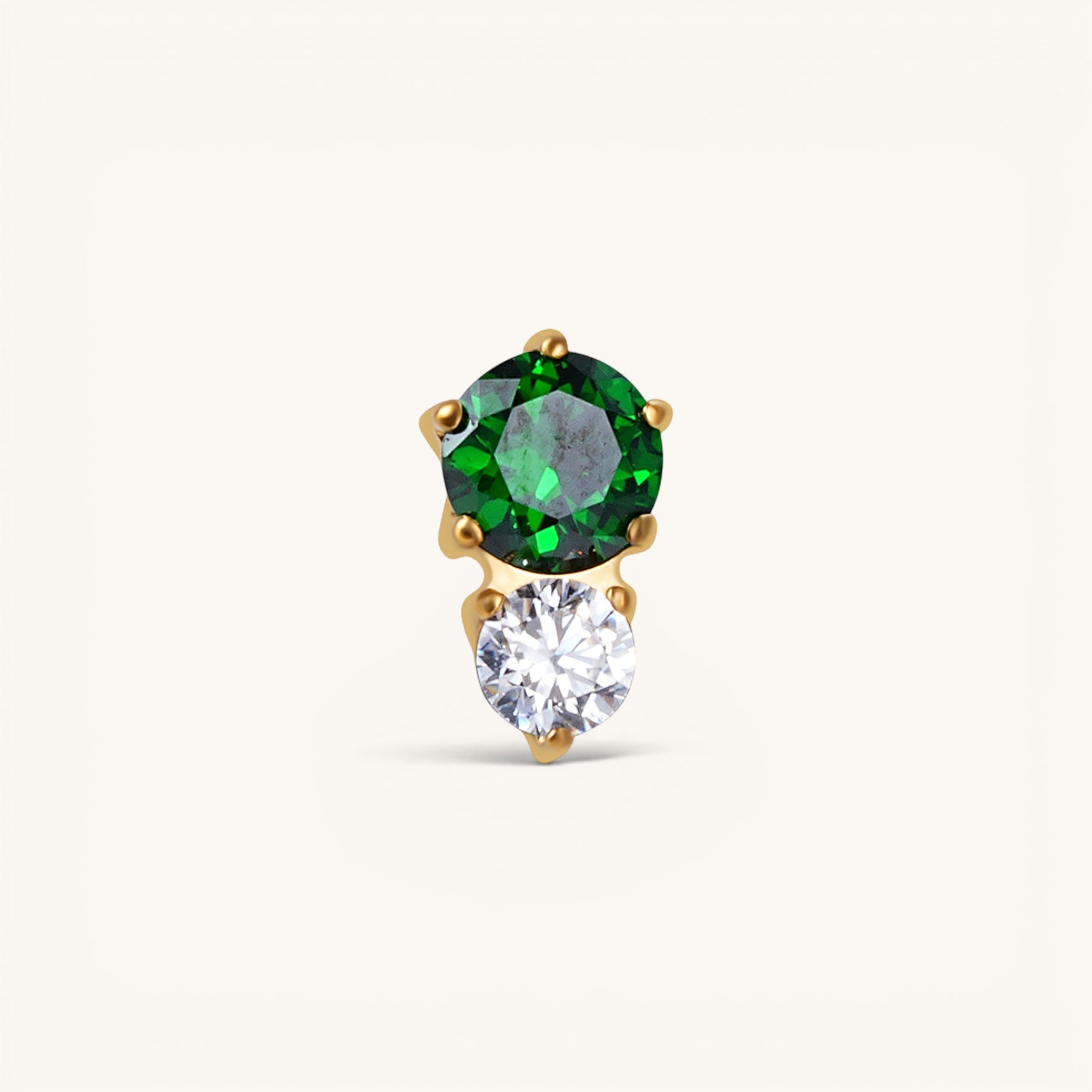 Nadare Co. threadless piercing jewelry featuring a stacked green and clear cubic zirconia stone design in gold.