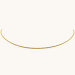 Nadare Co. Elena necklace featuring a delicate gold woven chain with a subtle shimmering texture.