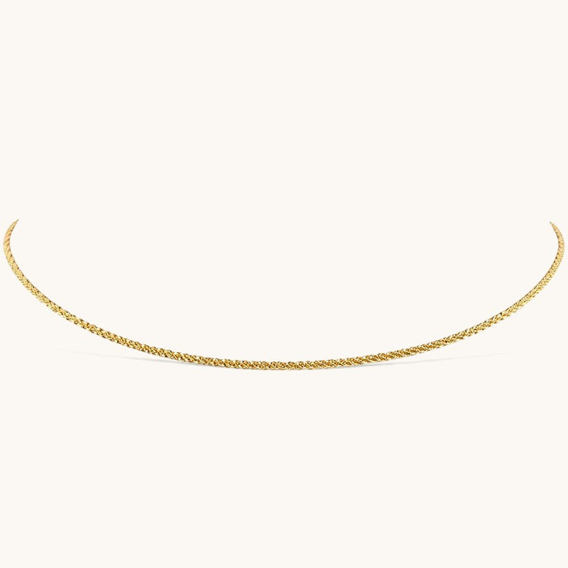 Nadare Co. Elena necklace featuring a delicate gold woven chain with a subtle shimmering texture.