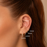 Nadare Co. Elodie Clicker Ring in gold with pavé-set cubic zirconia, shown in various sizes on a model's ear.
