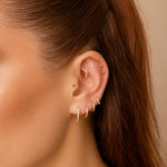 Nadare Co. Elodie Clicker Ring in gold-plated titanium with pavé cubic zirconia worn in a curated ear piercing stack.