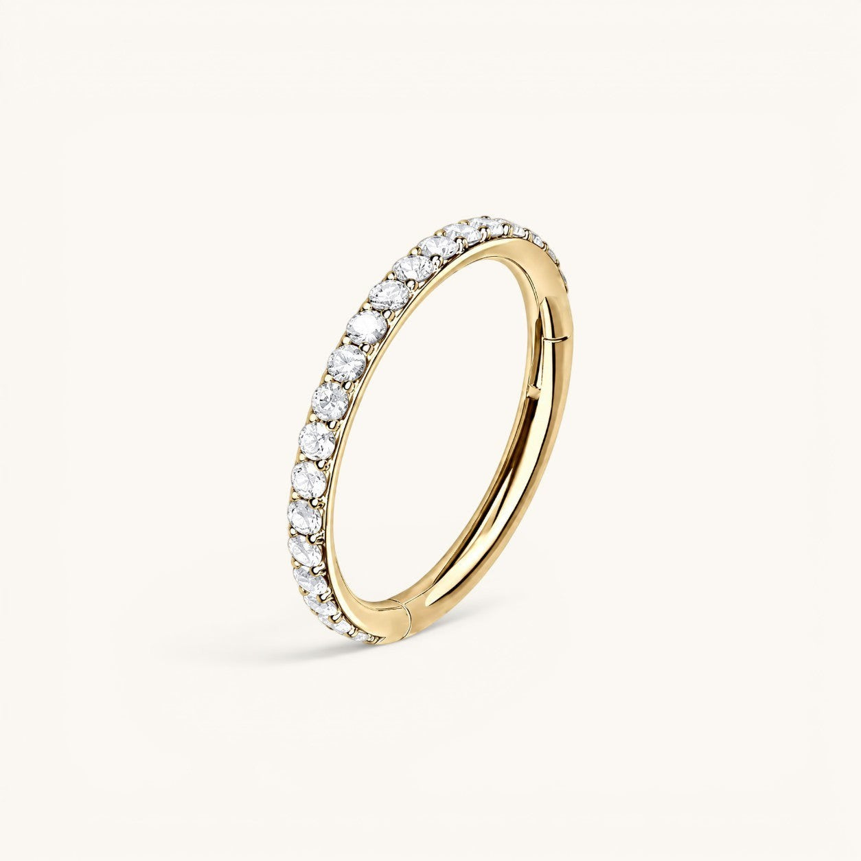 Nadare Co. Elodie Clicker Ring in gold-plated titanium with pavé-set cubic zirconia stones for piercings.
