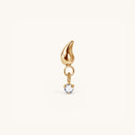 Nadare Co. Ember threadless piercing front in gold-plated titanium with a flame silhouette and cubic zirconia drop.
